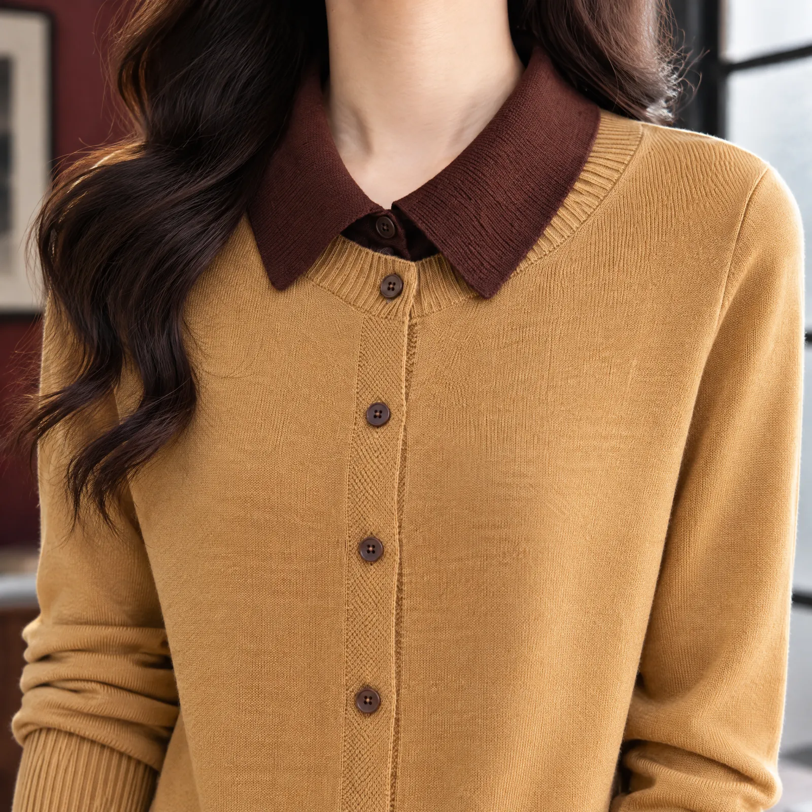 Close view of the cardigan collar, knit texture and button front